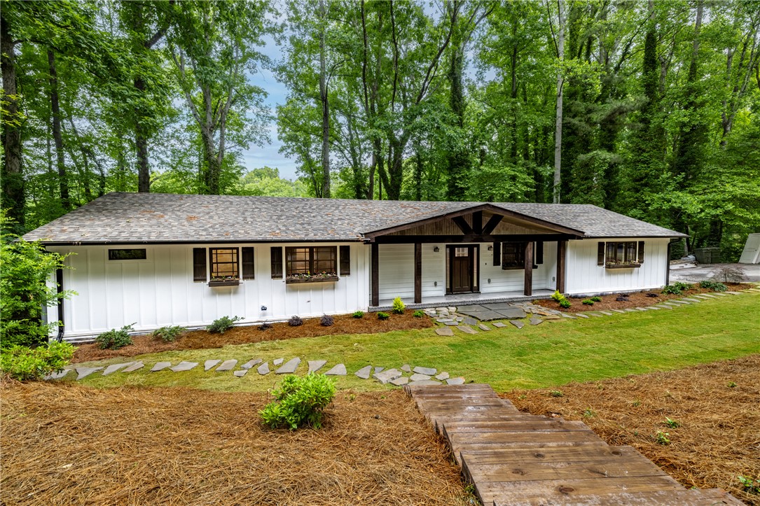 309 Woodland Way Clemson, SC 29631 - Photo 2 of 43 This charming residence is nestled among mature trees, offering a tranquil retreat with inviting curb appeal.