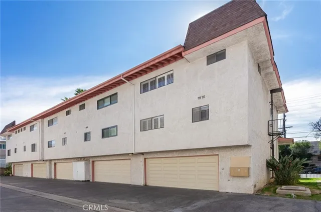 a large white building with a white fence