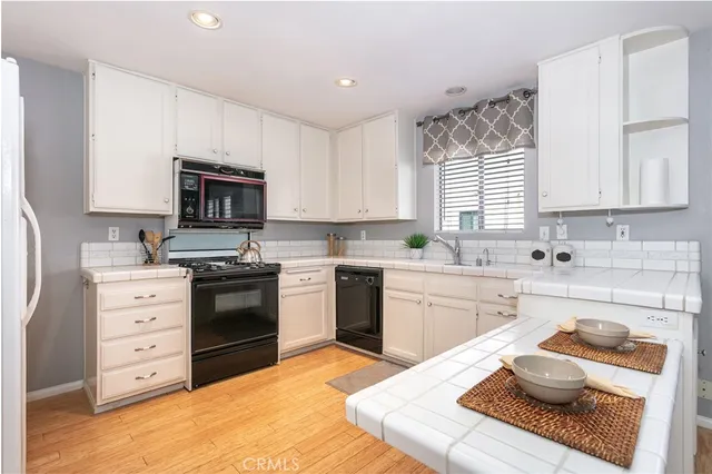 a kitchen with stainless steel appliances kitchen island granite countertop a sink cabinets and window