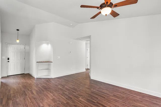 a backyard of a house with fountain table and chairs