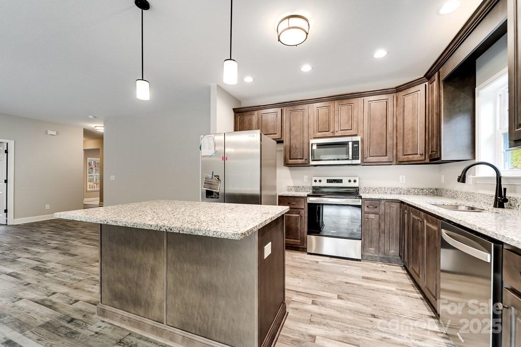 679 Firefly Road Whittier, NC 28789 - Photo 14 of 34 a kitchen with stainless steel appliances granite countertop a sink refrigerator and microwave