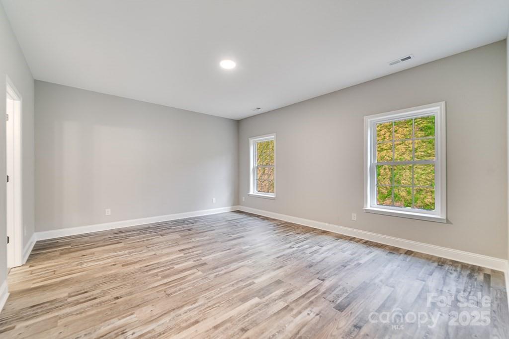 679 Firefly Road Whittier, NC 28789 - Photo 17 of 34 a view of an empty room with wooden floor and a window