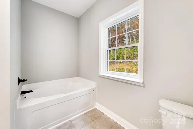 a white bath tub sitting next to a toilet