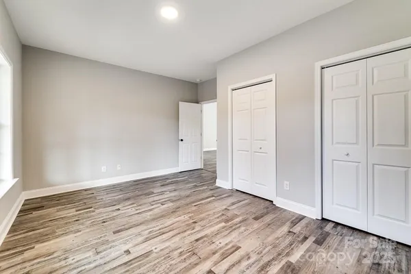 a view of an empty room and wooden floor