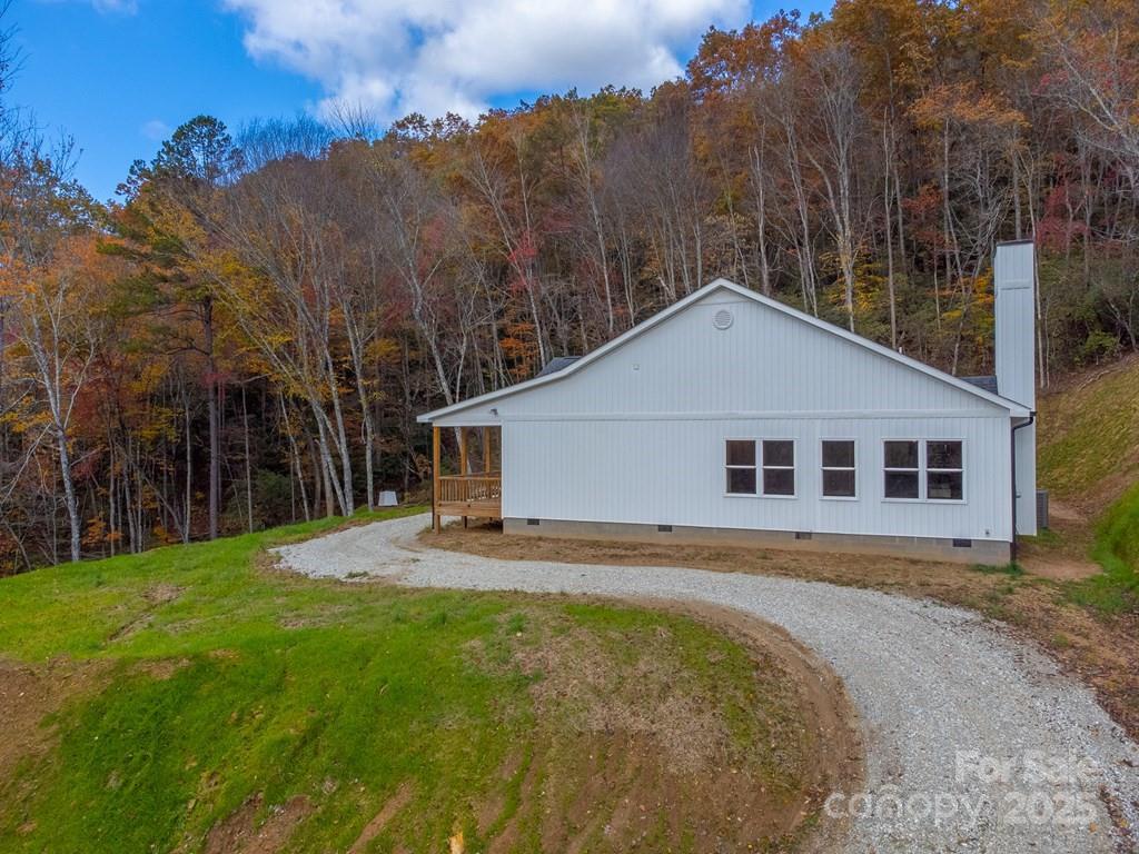 679 Firefly Road Whittier, NC 28789 - Photo 32 of 34 a front view of a house with a yard and trees