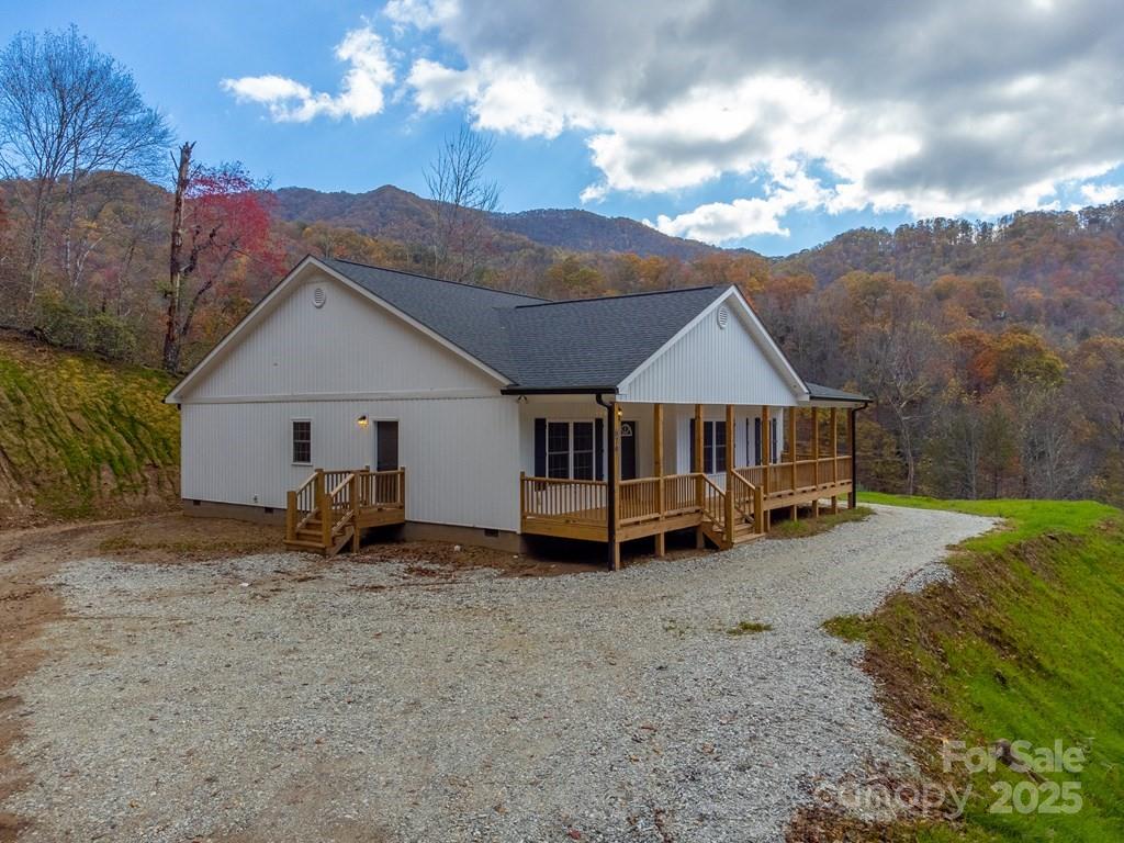 679 Firefly Road Whittier, NC 28789 - Photo 4 of 34 a view of a house with wooden fence