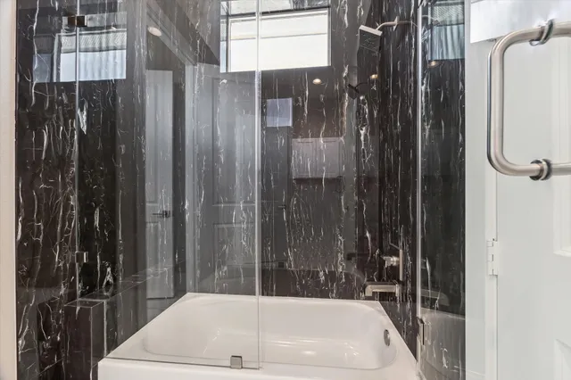 a bathroom with shower and bathtub