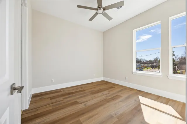a view of a room with wooden floor and white walls