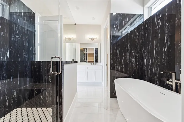 a bathroom with a bathtub a shower a sink and view of a bathtub