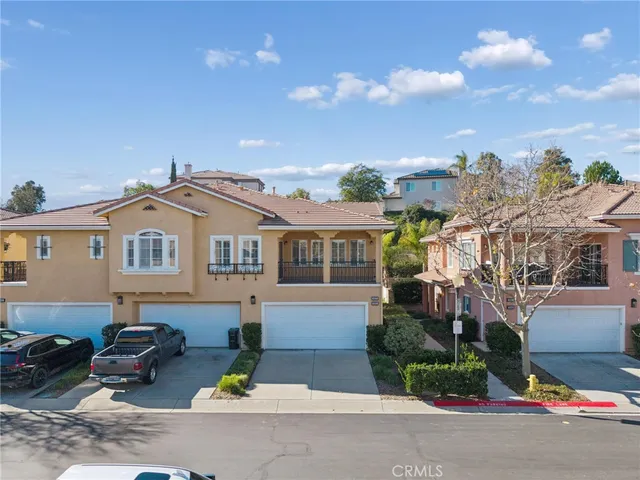 a front view of a house with a garden and plants