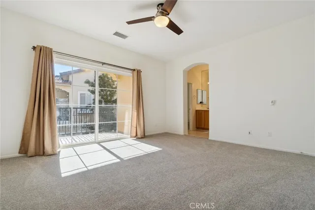a spacious bathroom with a mirror a sink and a mirror