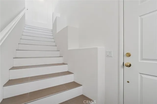 a view of a kitchen with a sink and a refrigerator