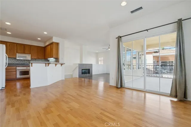 a view of an empty room with exposed radiator and fireplace