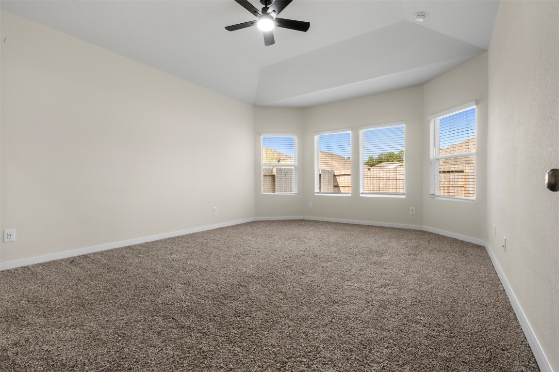1506 King Rnch Road Conroe, TX 77301 - Photo 13 of 32 an empty room with windows and ceiling fan