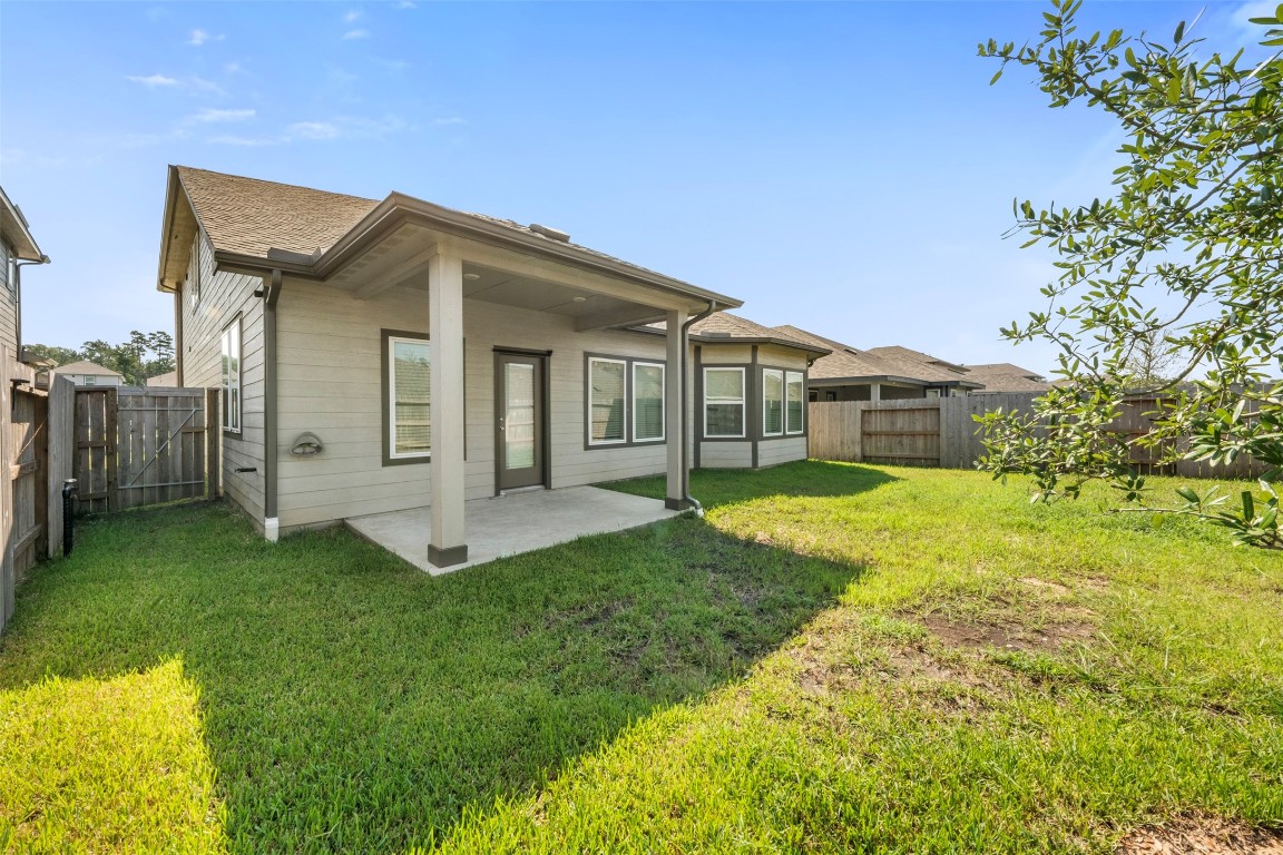 1506 King Rnch Road Conroe, TX 77301 - Photo 30 of 32 a view of a house with a yard and a porch