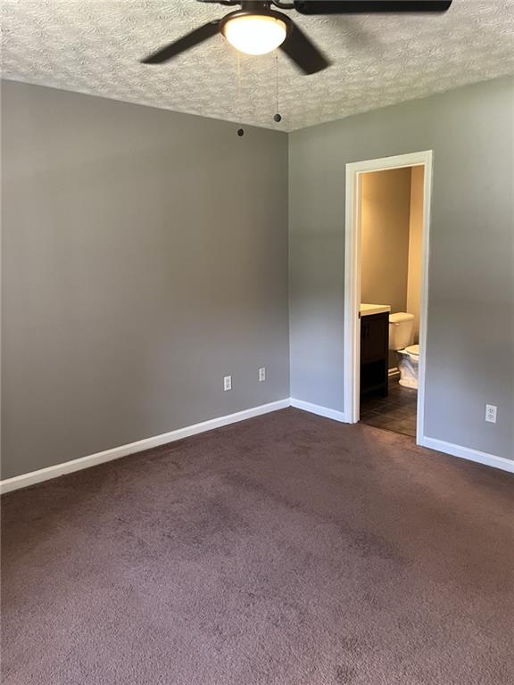 128 Tanner Drive Dallas, GA 30157 - Photo 12 of 23 an empty room with a chandelier fan and windows
