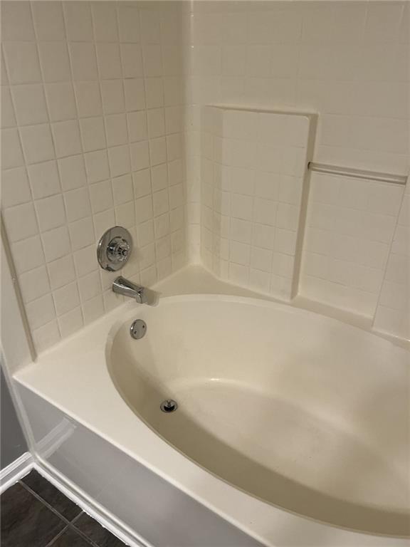 128 Tanner Drive Dallas, GA 30157 - Photo 14 of 23 a bathroom with a white bath tub and a shower