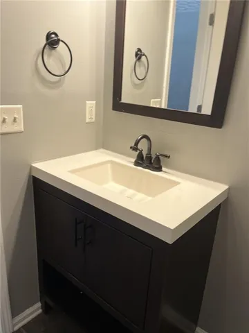 a bathroom with a sink vanity and a mirror