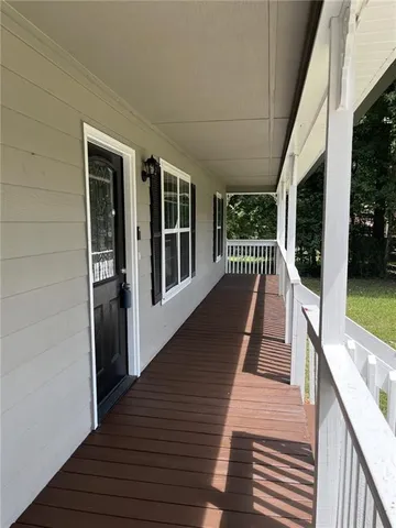 a view of balcony with wooden floor