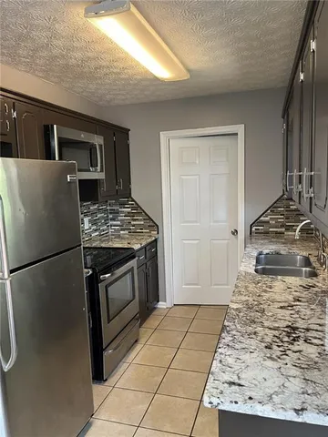 a kitchen with a stove and a refrigerator