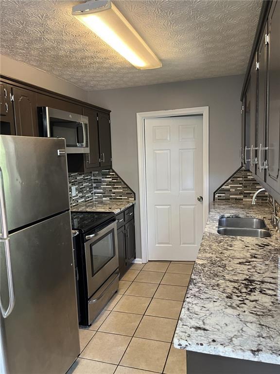128 Tanner Drive Dallas, GA 30157 - Photo 6 of 23 a kitchen with a stove and a refrigerator
