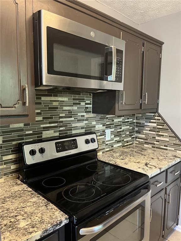 128 Tanner Drive Dallas, GA 30157 - Photo 7 of 23 a kitchen with a stove and a microwave