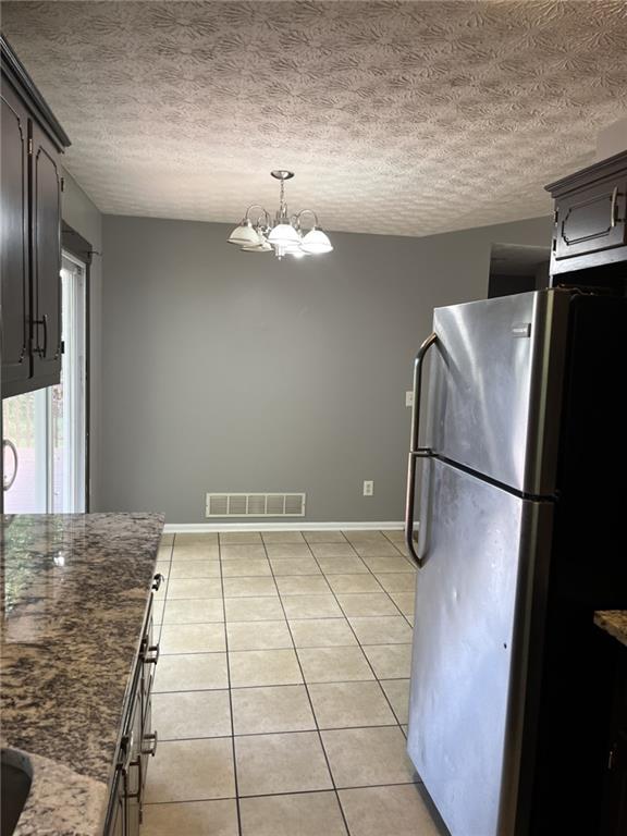 128 Tanner Drive Dallas, GA 30157 - Photo 9 of 23 a view of a refrigerator in kitchen and an empty room