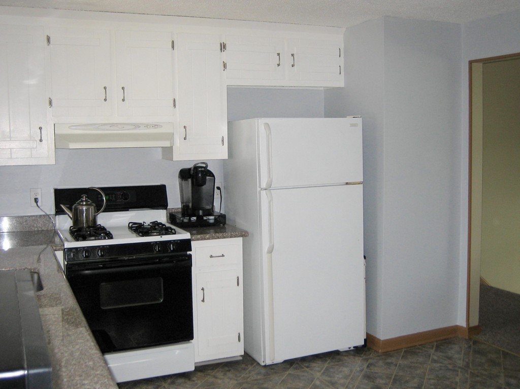 6 Rachel Road Dracut, MA 01826 - Photo 6 of 25 a kitchen with a stove and white cabinets