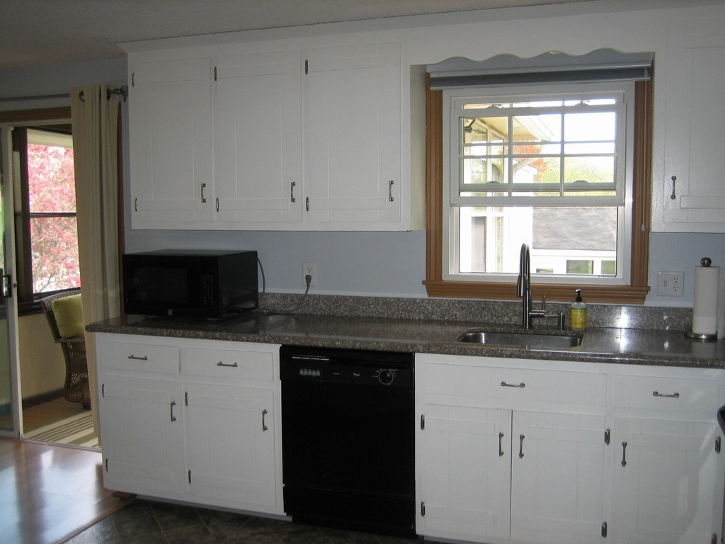 6 Rachel Road Dracut, MA 01826 - Photo 7 of 25 a kitchen with granite countertop white cabinets white appliances and a sink