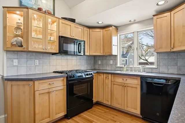 a kitchen with a sink cabinets and wooden floor
