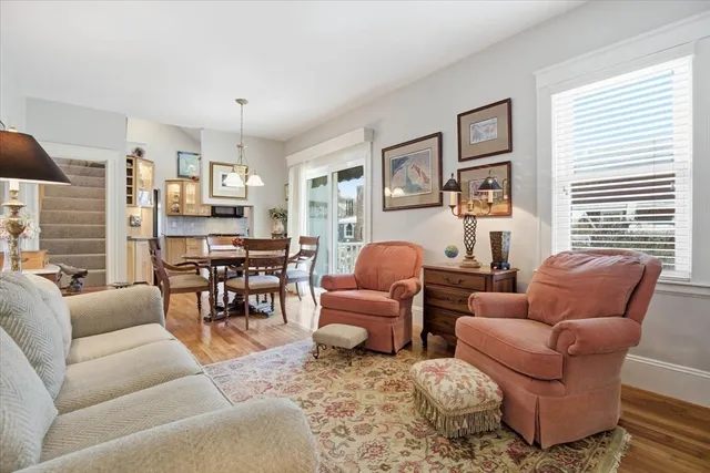a living room with furniture a flat screen tv and a window