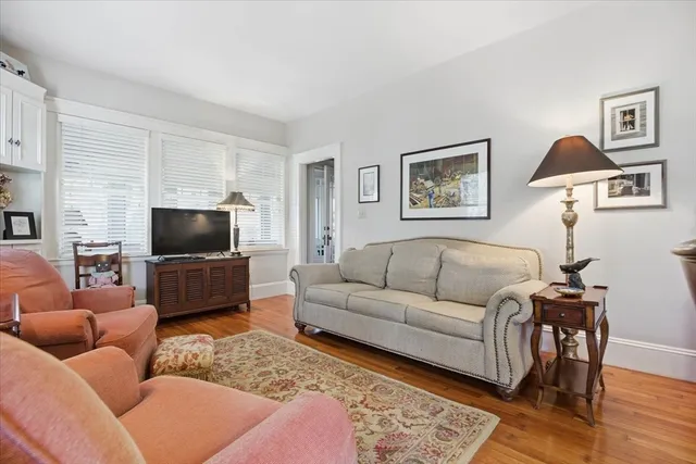 a living room with furniture a rug and a chandelier