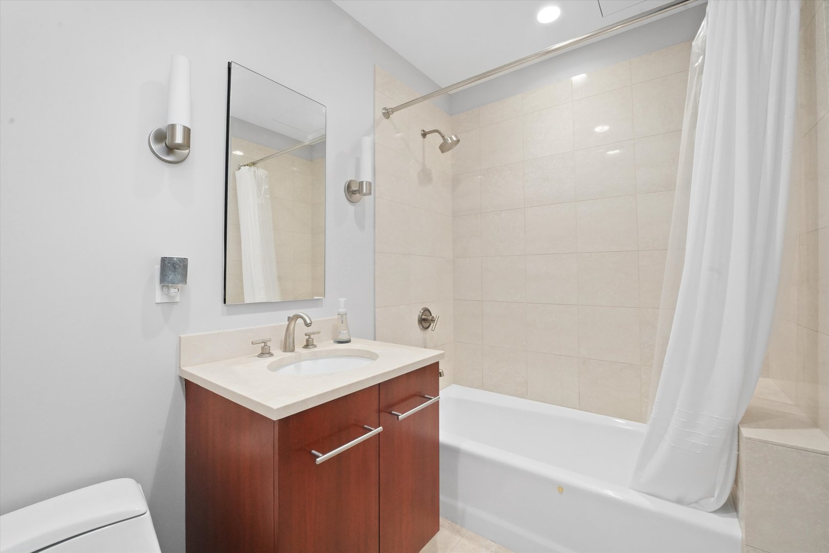 401 North Wabash Avenue, Unit 81F Chicago, IL 60611 - Photo 11 of 16 a bathroom with a sink mirror toilet and bathtub