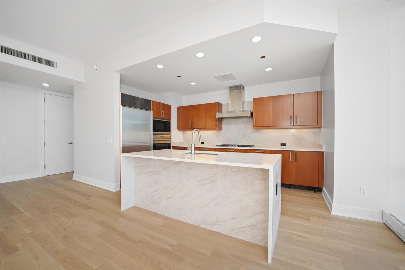 401 North Wabash Avenue, Unit 81F Chicago, IL 60611 - Photo 4 of 16 a large kitchen with stainless steel appliances kitchen island granite countertop a refrigerator and a sink