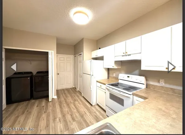 a kitchen with stainless steel appliances kitchen island granite countertop a refrigerator stove and sink