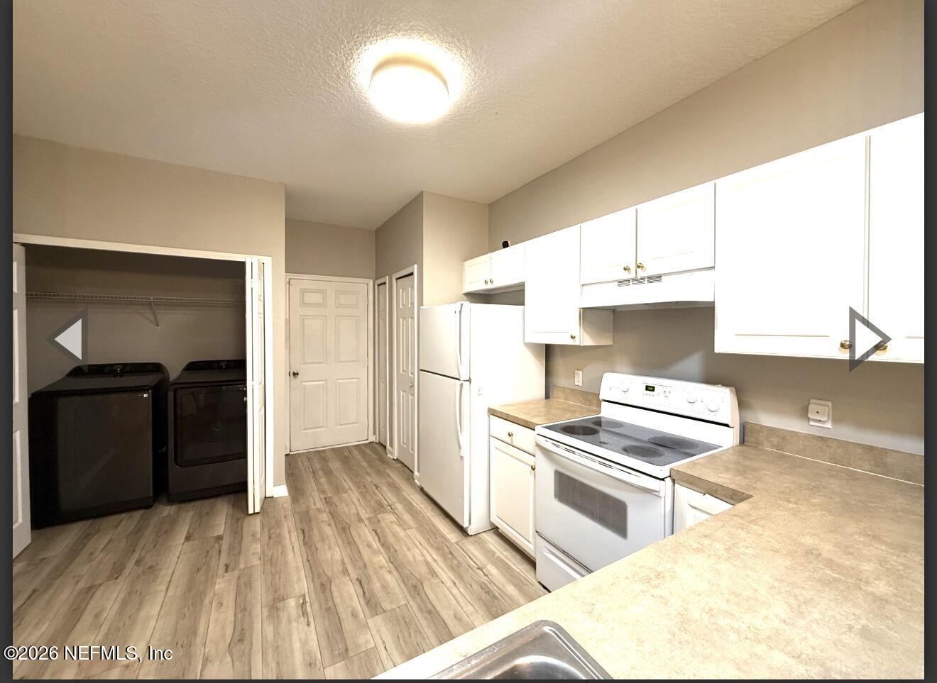 7850 Melvin Road Jacksonville, FL 32210 - Photo 3 of 12 a kitchen with stainless steel appliances kitchen island granite countertop a refrigerator stove and sink