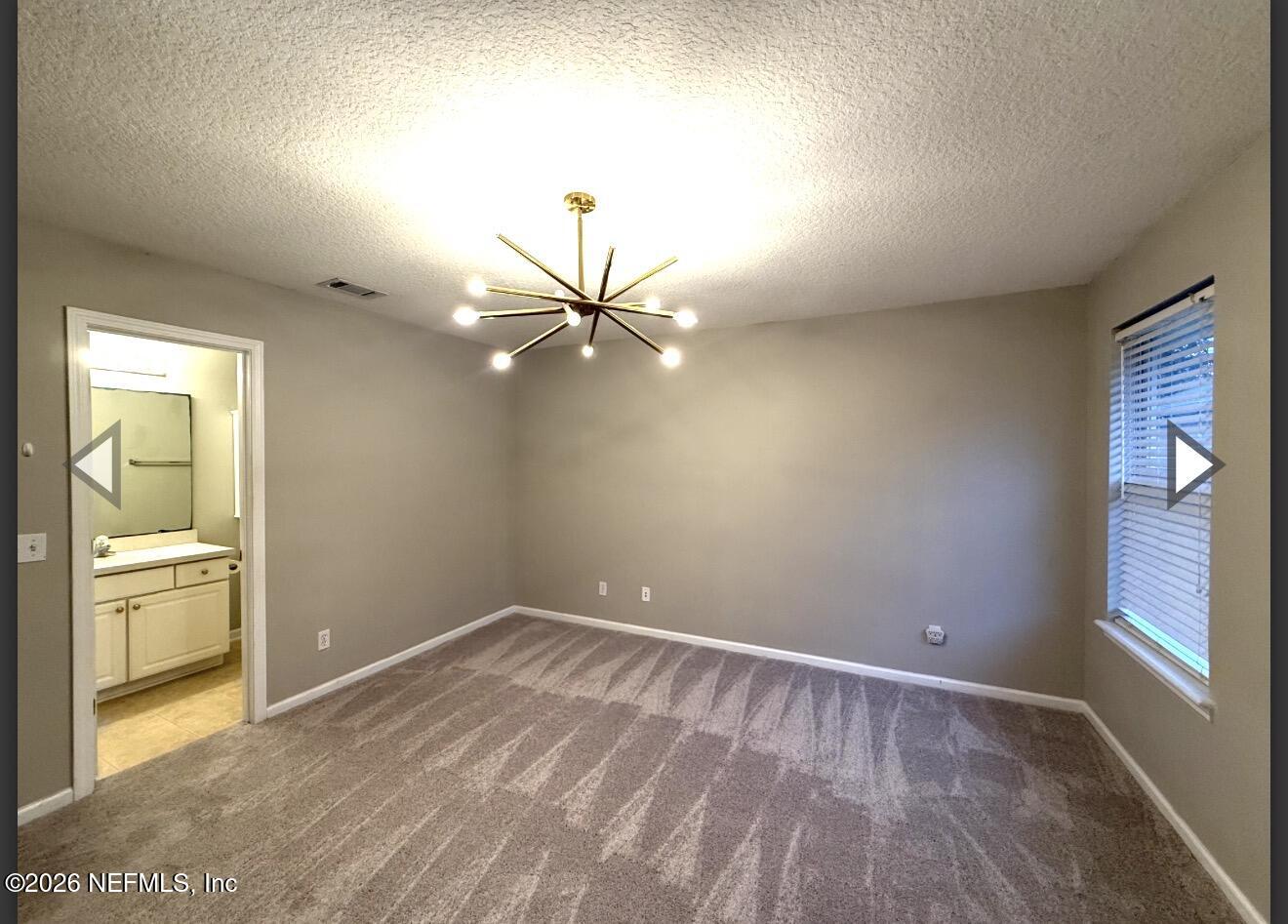 7850 Melvin Road Jacksonville, FL 32210 - Photo 7 of 12 wooden floor in an empty room with a window