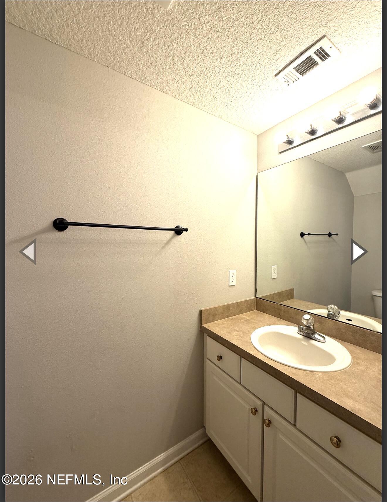 7850 Melvin Road Jacksonville, FL 32210 - Photo 10 of 12 a bathroom with a sink and mirror