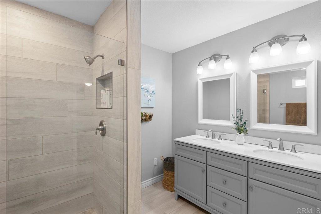 30405 Del Rey Road Temecula, CA 92591 - Photo 11 of 46 a bathroom with double vanity sink and a mirror