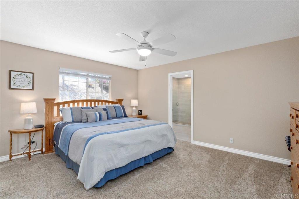 30405 Del Rey Road Temecula, CA 92591 - Photo 13 of 46 a bedroom with a bed and a chandelier