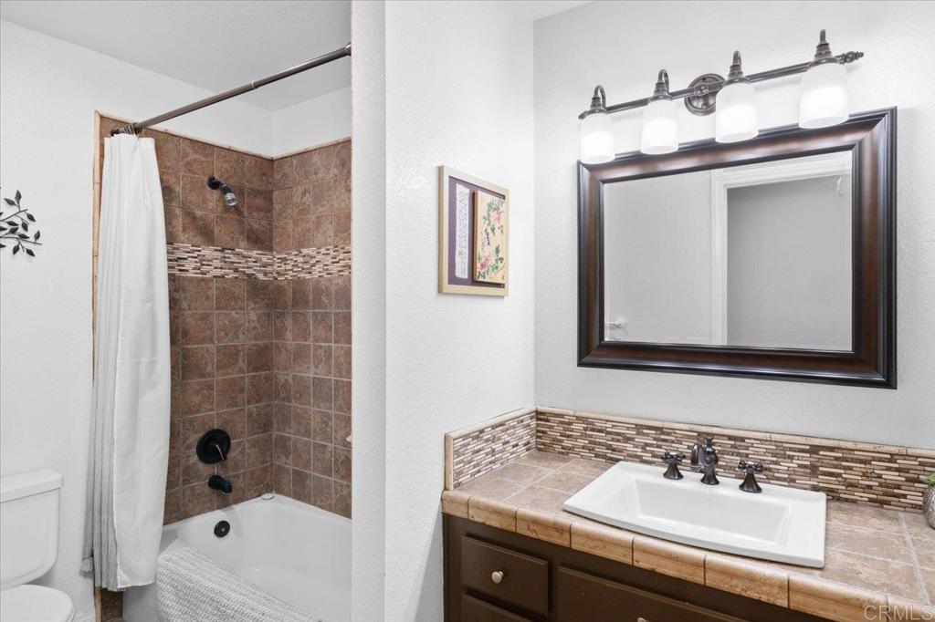 30405 Del Rey Road Temecula, CA 92591 - Photo 15 of 46 a bathroom with a sink a mirror and a bathtub