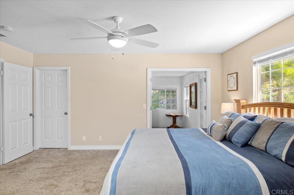 30405 Del Rey Road Temecula, CA 92591 - Photo 42 of 46 a bedroom with a large bed and a chandelier fan