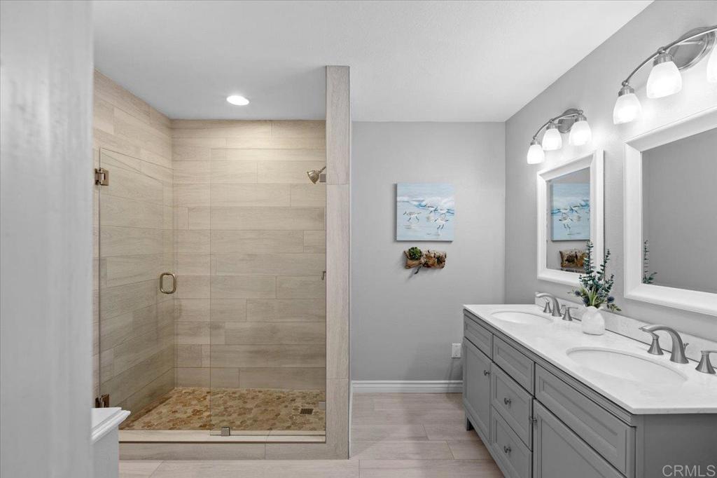 30405 Del Rey Road Temecula, CA 92591 - Photo 8 of 46 a bathroom with a shower sink and mirror