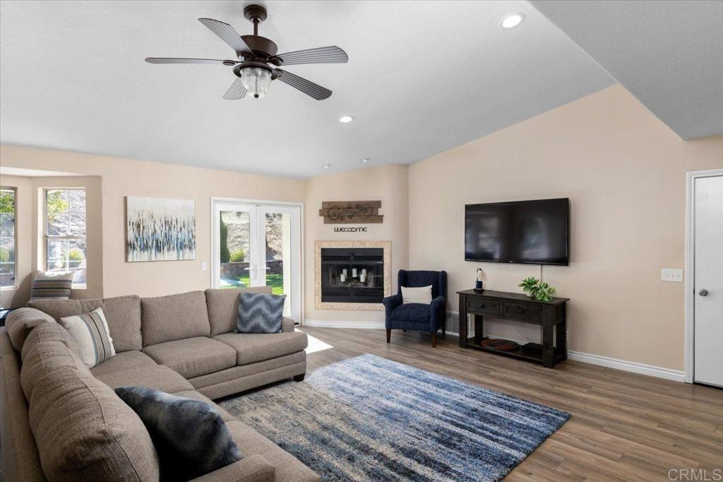 30405 Del Rey Road Temecula, CA 92591 - Photo 9 of 46 a living room with furniture a flat screen tv and a fireplace