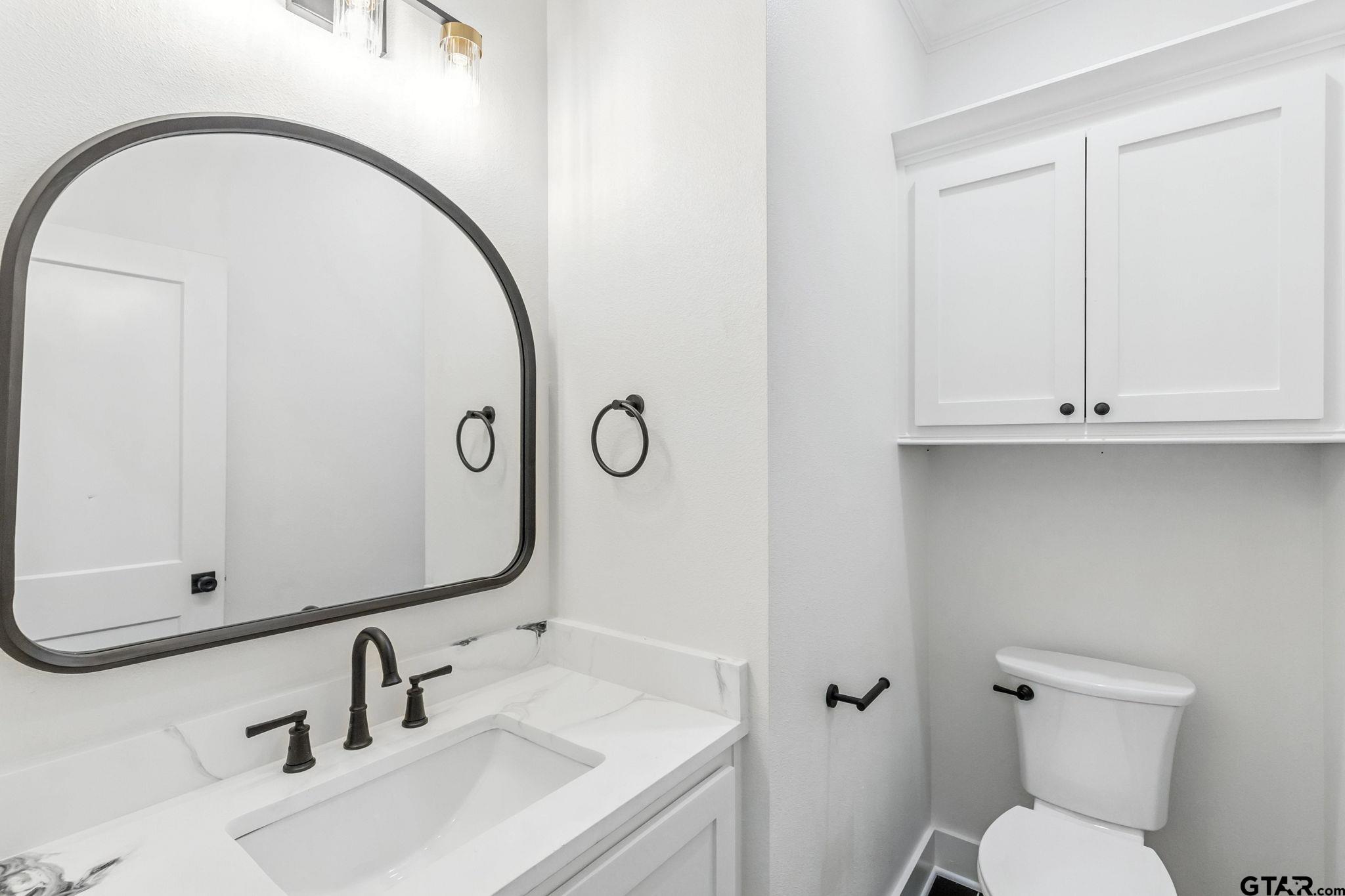 15524 County Road 434 Lindale, TX 75771 - Photo 17 of 23 a bathroom with a sink and mirror with toilet