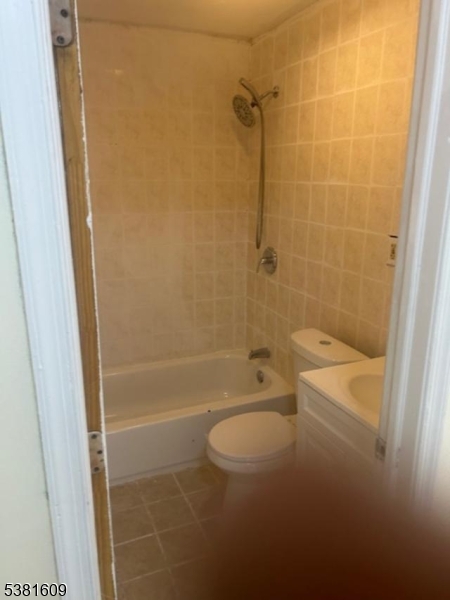 41 Myrtle Avenue Newark, NJ 07107 - Photo 5 of 10 a bathroom with a granite countertop bathtub shower and toilet