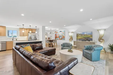 a living room with furniture kitchen and a table