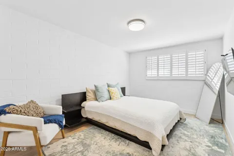 a bedroom with a bed and a couch