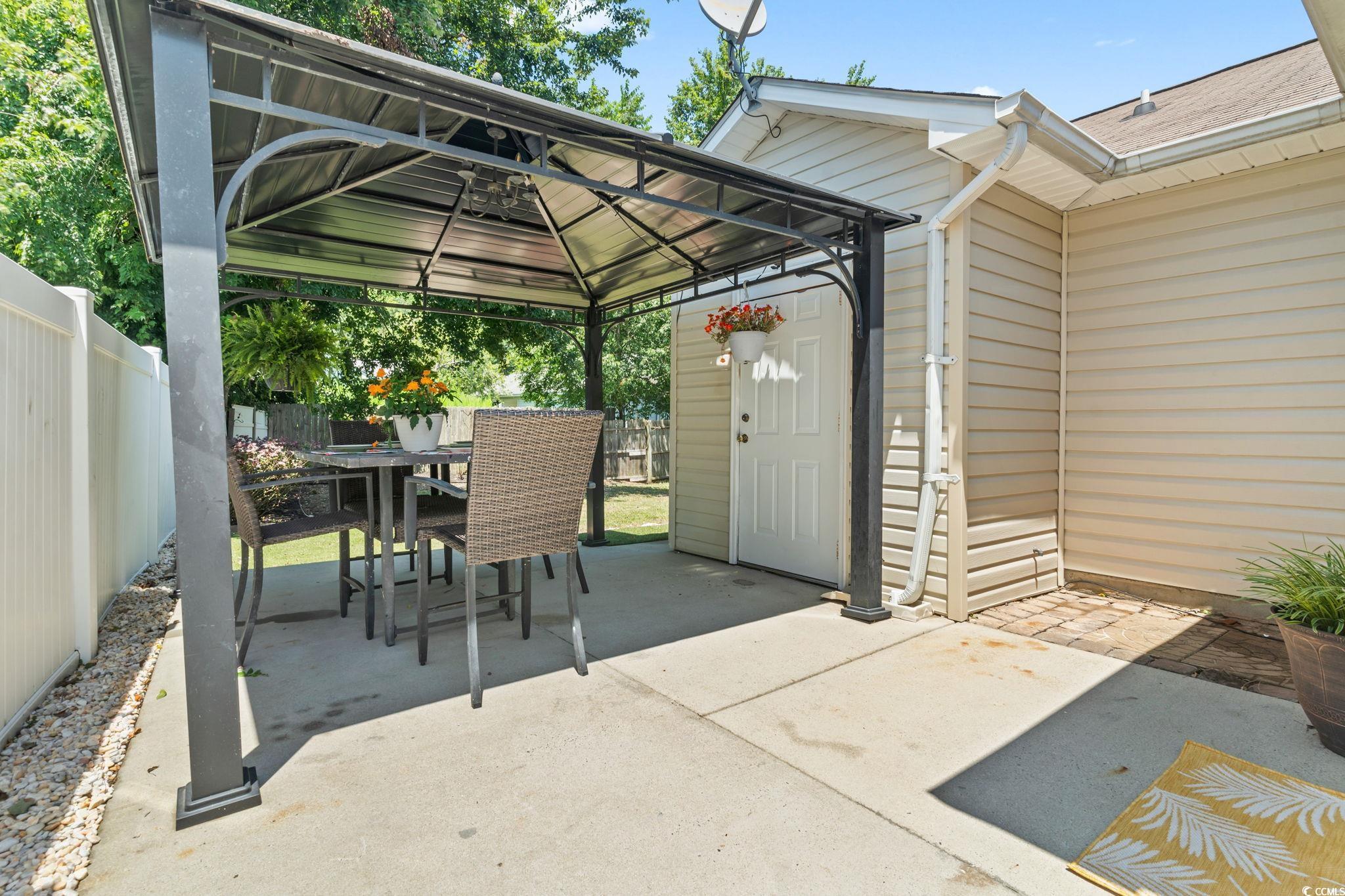 1007 Autumn Drive Murrells Inlet, SC 29576 - Photo 28 of 33 Fenced backyard with a patio area, outdoor dining space, and a gazebo