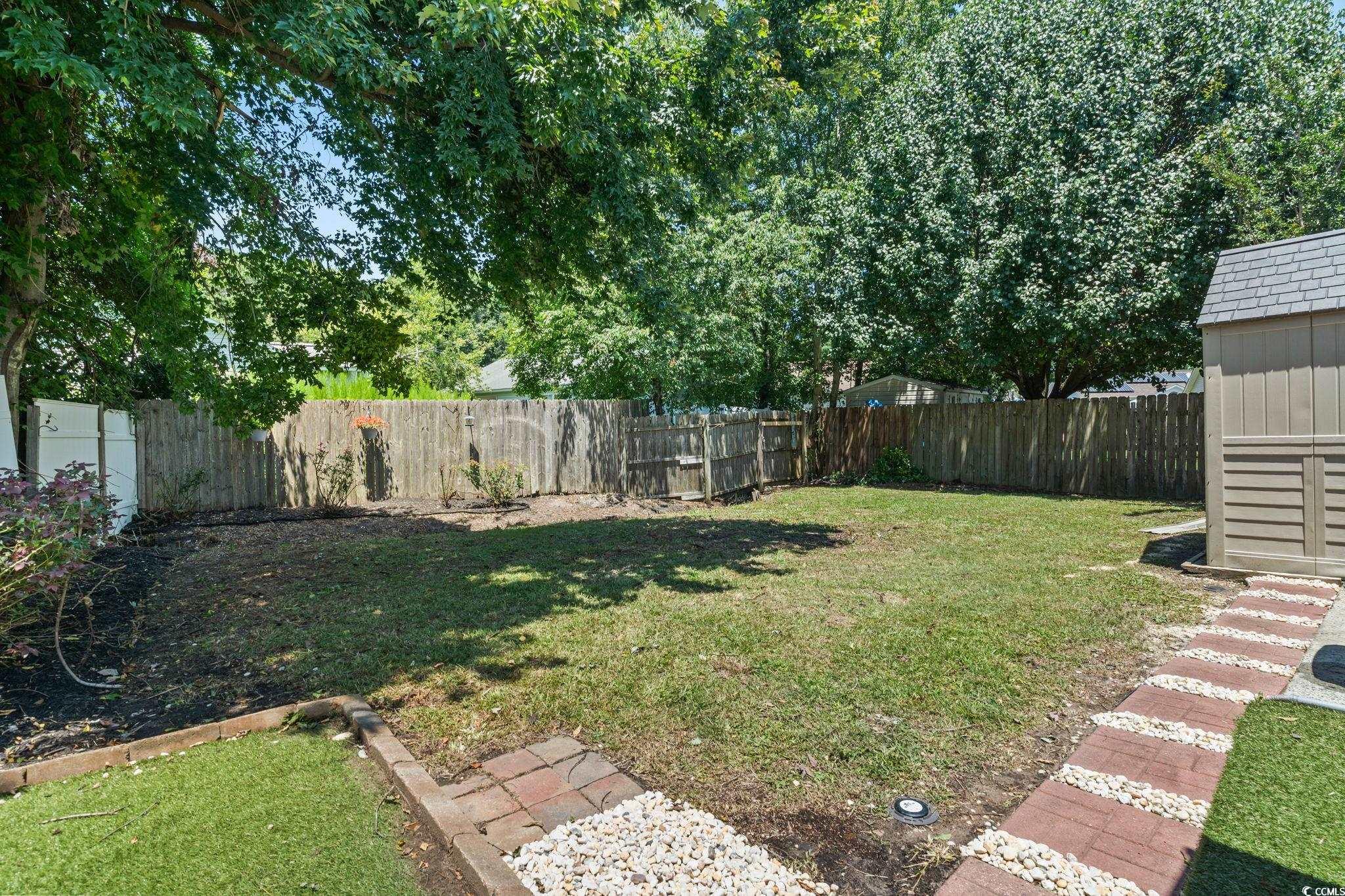 1007 Autumn Drive Murrells Inlet, SC 29576 - Photo 31 of 33 Fenced backyard featuring a storage unit